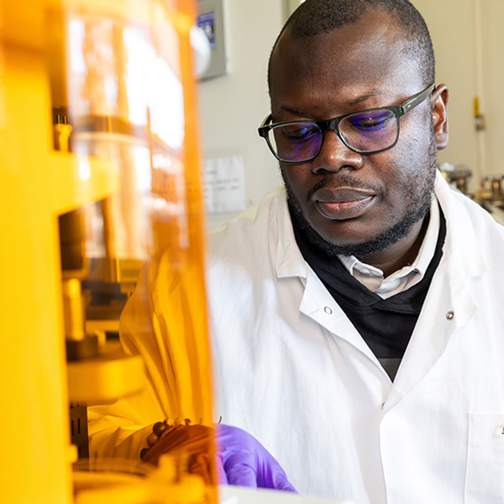 Dr. Emmanuel Osei in working with a 3D printer